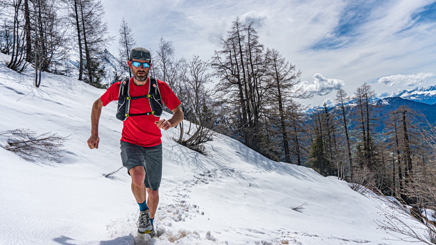 Scotty Cornish trail running on a mountain path.